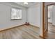 An empty room with faux wood floors with a closet and light from the large window at 749 E Wisconsin Ave, Orange City, FL 32763