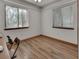Bright bedroom with wood floors and natural light from two windows at 749 E Wisconsin Ave, Orange City, FL 32763