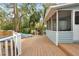 Wooden deck leads to screened porch, pool and backyard at 749 E Wisconsin Ave, Orange City, FL 32763