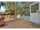 Wooden deck with a screened in porch and a view of the backyard at 749 E Wisconsin Ave, Orange City, FL 32763