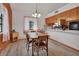 Cozy dining area with wood-look floors, a chandelier, and kitchen views at 749 E Wisconsin Ave, Orange City, FL 32763