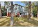 Charming two-story home with light blue siding, red brick, and a well-maintained front yard at 749 E Wisconsin Ave, Orange City, FL 32763