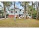 Two-story home featuring light blue siding and red brick foundation with a manicured lawn at 749 E Wisconsin Ave, Orange City, FL 32763