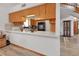 Bright kitchen featuring wood cabinets, light countertops, and modern backsplash, open to the living area at 749 E Wisconsin Ave, Orange City, FL 32763