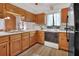 Bright kitchen with wood cabinets, stainless steel sink, and modern appliances at 749 E Wisconsin Ave, Orange City, FL 32763