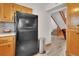 View of the kitchen featuring wood cabinets, stainless steel refrigerator and a staircase at 749 E Wisconsin Ave, Orange City, FL 32763