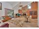 Spacious living room featuring a brick fireplace, wood paneling, and vaulted ceilings at 749 E Wisconsin Ave, Orange City, FL 32763