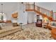 Open-concept living space featuring wood-look floors, a staircase, and views of the kitchen at 749 E Wisconsin Ave, Orange City, FL 32763