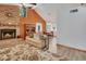 Inviting living room with a brick fireplace, vaulted ceilings, and wood-look floors at 749 E Wisconsin Ave, Orange City, FL 32763