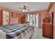 Main bedroom featuring ensuite bath, ceiling fan, and access to balcony at 749 E Wisconsin Ave, Orange City, FL 32763