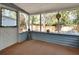 Inviting sunroom featuring screened windows and a cozy carpeted floor at 749 E Wisconsin Ave, Orange City, FL 32763