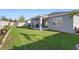 Picture of the backyard, showing the covered patio, lush grass, and new landscaping at 875 Honey Petal Ln, Deland, FL 32720