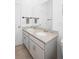 Bathroom features a double sink vanity with granite counters and modern fixtures at 875 Honey Petal Ln, Deland, FL 32720