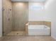 Beautiful bathroom featuring a glass shower, bathtub, and stylish tile at 875 Honey Petal Ln, Deland, FL 32720