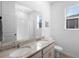 Bright bathroom features double sinks, granite counters, and a shower and tub combo at 875 Honey Petal Ln, Deland, FL 32720
