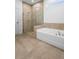 Elegant bathroom featuring a glass shower, bathtub, and stylish tile accents at 875 Honey Petal Ln, Deland, FL 32720