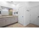 Bathroom with double sink vanity with granite counters, tile floors, and white cabinets at 875 Honey Petal Ln, Deland, FL 32720
