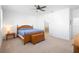 Cozy bedroom featuring a wooden bed frame, a ceiling fan, and an ensuite bathroom at 875 Honey Petal Ln, Deland, FL 32720