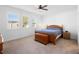 Bright bedroom with a wooden bed frame, and large windows with plantation shutters at 875 Honey Petal Ln, Deland, FL 32720