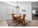 Inviting dining area with wooden table, chairs, and decorative rug at 875 Honey Petal Ln, Deland, FL 32720