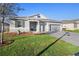 Charming single-Gathering home with a two-car garage, manicured lawn, and stone accents at 875 Honey Petal Ln, Deland, FL 32720