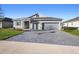 Charming single-Gathering home featuring a paved driveway and three-car garage at 875 Honey Petal Ln, Deland, FL 32720