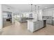 Bright, open-concept kitchen with island seating, stainless steel appliances, and views to the living room at 875 Honey Petal Ln, Deland, FL 32720
