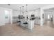 Modern kitchen featuring a large island, stainless steel appliances, and sleek white cabinetry at 875 Honey Petal Ln, Deland, FL 32720