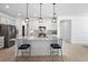 Modern kitchen features a large island, granite counters, stainless steel appliances, and pendant lighting at 875 Honey Petal Ln, Deland, FL 32720