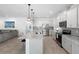 Modern kitchen featuring white cabinets, stainless steel appliances, granite countertops, and pendant lighting at 875 Honey Petal Ln, Deland, FL 32720