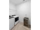Well lit laundry room includes a washer, dryer, storage rack, and wine cooler at 875 Honey Petal Ln, Deland, FL 32720