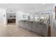 Cozy living room with a gray sectional sofa, tile floors, and views of the backyard at 875 Honey Petal Ln, Deland, FL 32720