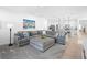 Bright living space features a gray sectional sofa, and neutral decor for a welcoming atmosphere at 875 Honey Petal Ln, Deland, FL 32720