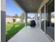 Covered patio with view of the backyard, lush lawn, and fenced property at 875 Honey Petal Ln, Deland, FL 32720