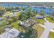 Aerial view of the property highlighting the home's setting near a lake and lush landscaping at 953 Pineapple Rd, South Daytona, FL 32119