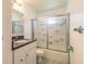 Bathroom features a vanity with granite countertop and walk-in shower with glass doors at 953 Pineapple Rd, South Daytona, FL 32119