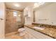 Bathroom with a granite countertop, tiled shower, and glass doors at 953 Pineapple Rd, South Daytona, FL 32119
