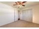 Bedroom featuring neutral carpet, ceiling fan, closet, and doorway to another room at 953 Pineapple Rd, South Daytona, FL 32119