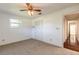 Bedroom features neutral carpet, ceiling fan with lights, and double-door closet at 953 Pineapple Rd, South Daytona, FL 32119
