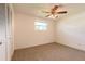 Carpeted bedroom with a ceiling fan, closet, and bright natural light at 953 Pineapple Rd, South Daytona, FL 32119