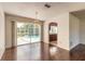 Dining room with hardwood floors, chandelier, and views of the pool and patio at 953 Pineapple Rd, South Daytona, FL 32119
