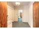 Bright hallway with neutral walls and flooring leading to other rooms, providing seamless transitions throughout the home at 953 Pineapple Rd, South Daytona, FL 32119