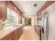 Spacious kitchen showcases updated appliances and view of outdoor pool at 953 Pineapple Rd, South Daytona, FL 32119