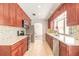 Long kitchen with stainless appliances, ample cabinet space, and stone countertops at 953 Pineapple Rd, South Daytona, FL 32119