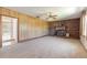 Living room with brick fireplace, wood paneling and view of pool area at 953 Pineapple Rd, South Daytona, FL 32119