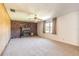 Large living room with brick fireplace, wood paneling, and ample natural light at 953 Pineapple Rd, South Daytona, FL 32119