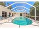 Inviting pool area with clear water, enclosed by a screened lanai for outdoor relaxation and enjoyment at 953 Pineapple Rd, South Daytona, FL 32119