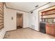 Wet bar area with storage and a compact refrigerator for entertaining at 953 Pineapple Rd, South Daytona, FL 32119