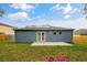Backyard with solar panels and a patio, ideal for outdoor relaxation and eco-friendly living at 971 Cascades Park Trl, Deland, FL 32720