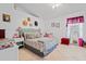 Bright bedroom featuring a decorative headboard and a sitting area with unique wall decor at 971 Cascades Park Trl, Deland, FL 32720